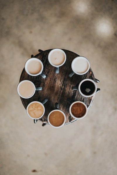 平面摄影的八个拿铁咖啡杯在圆桌上
